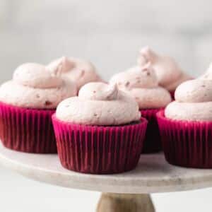 Chocolate cherry cupcakes on cake stand.