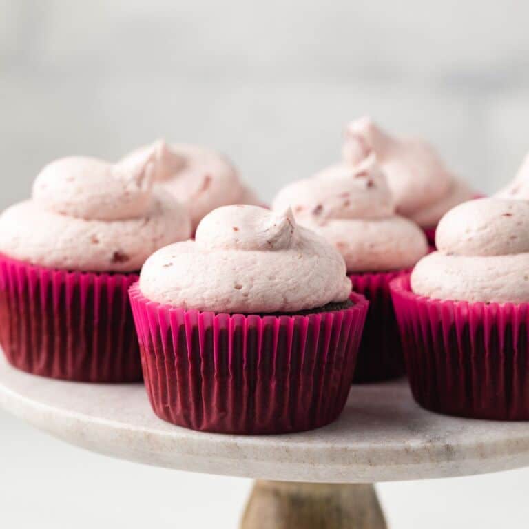 Chocolate cherry cupcakes on cake stand.