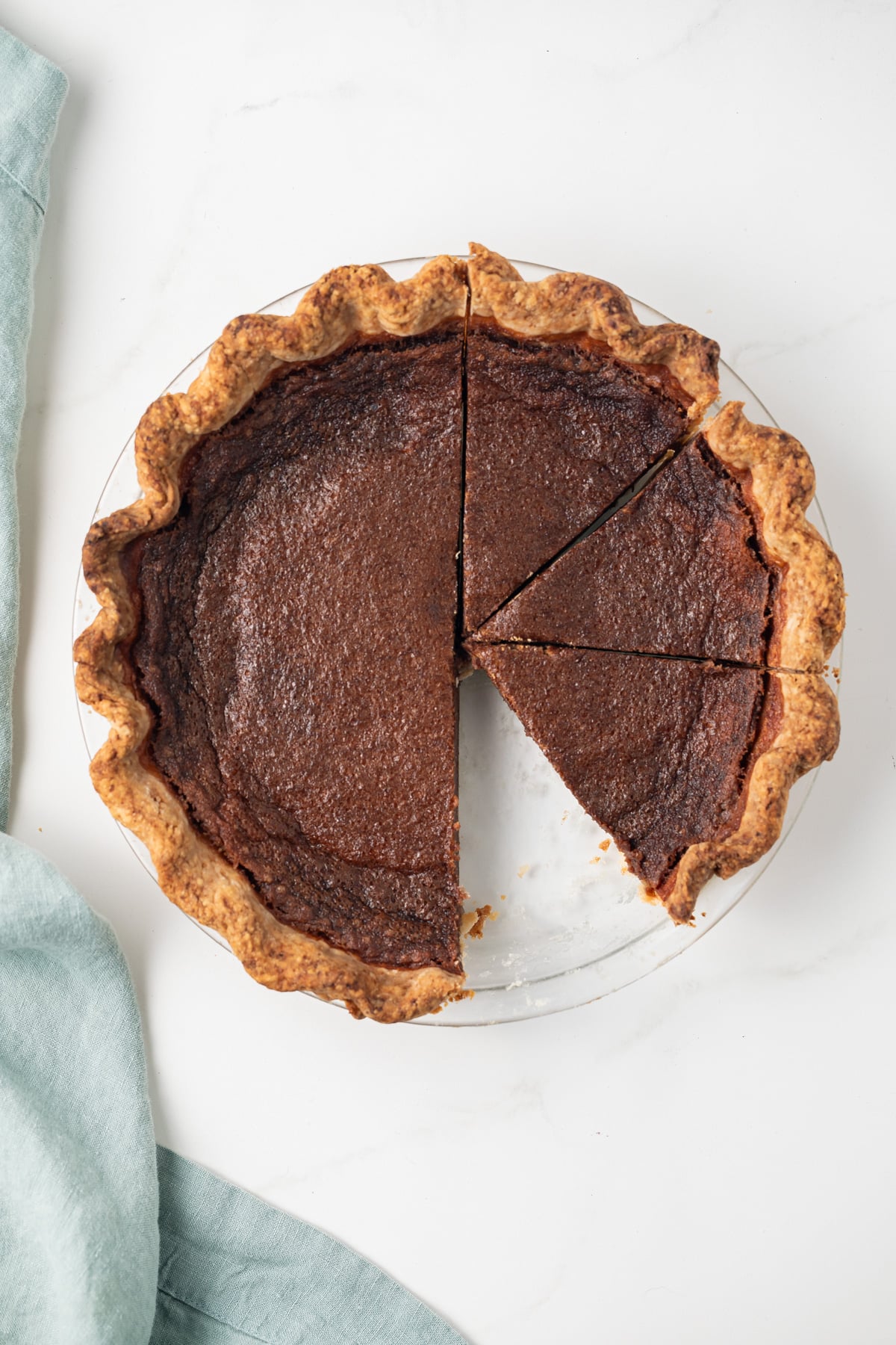 Chocolate chess pie with a slice taken out.