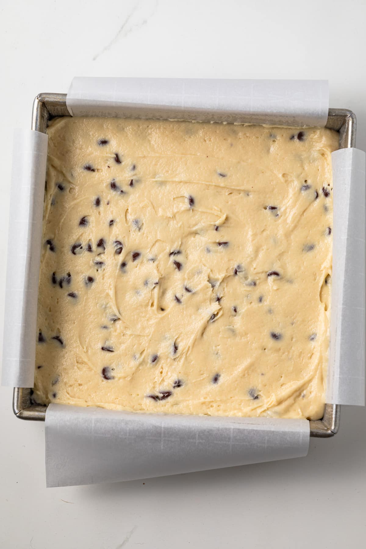 Coffee cake batter spread in a square pan.