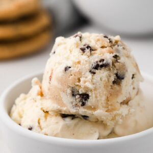 close up of chocolate chip cookie dough ice cream scooped into white bowl