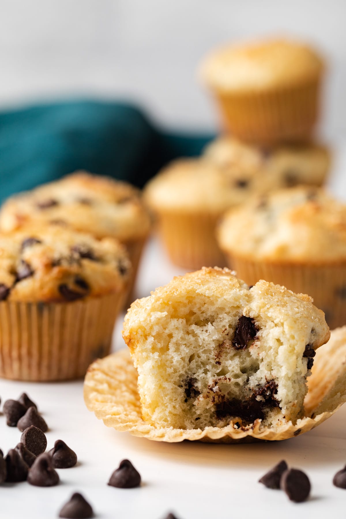 side view of chocolate chip muffin with a bite taken out so the inside is visible