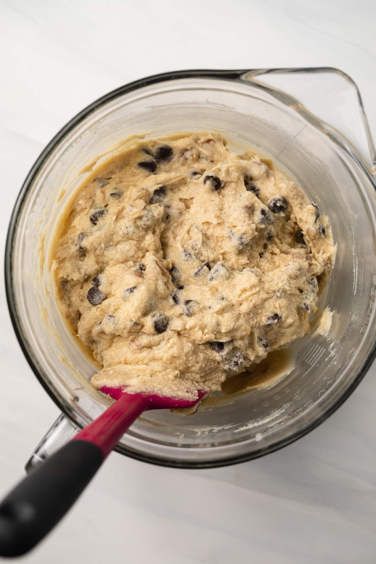 Chocolate chip pie filling in glass mixing bowl.