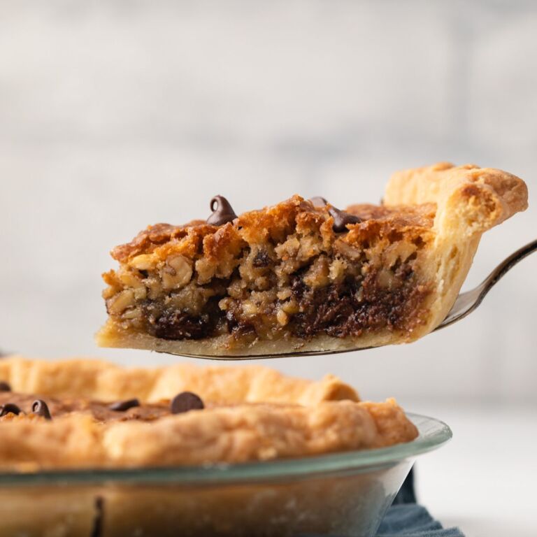 Slice being removed from chocolate chip pie.