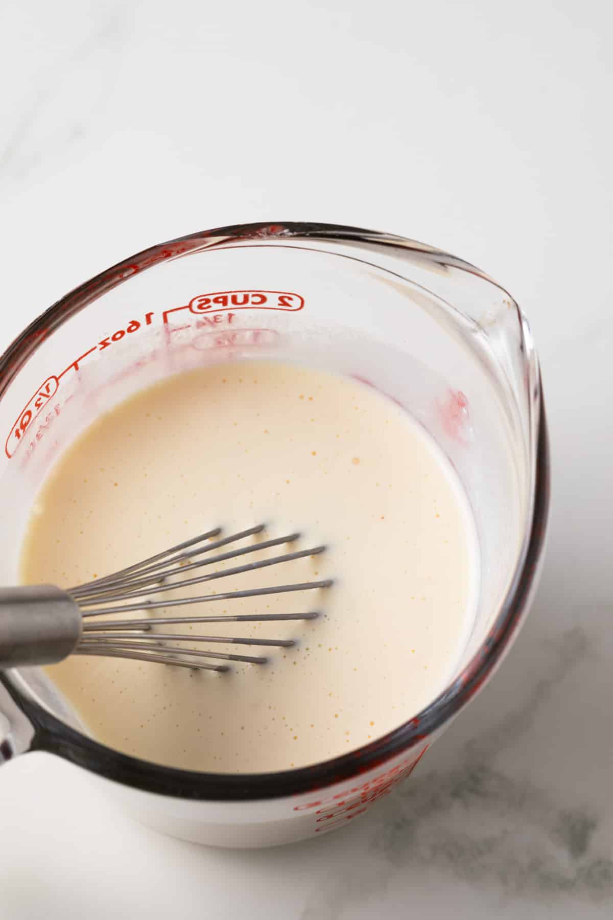 Wet ingredients mixed in measuring up.
