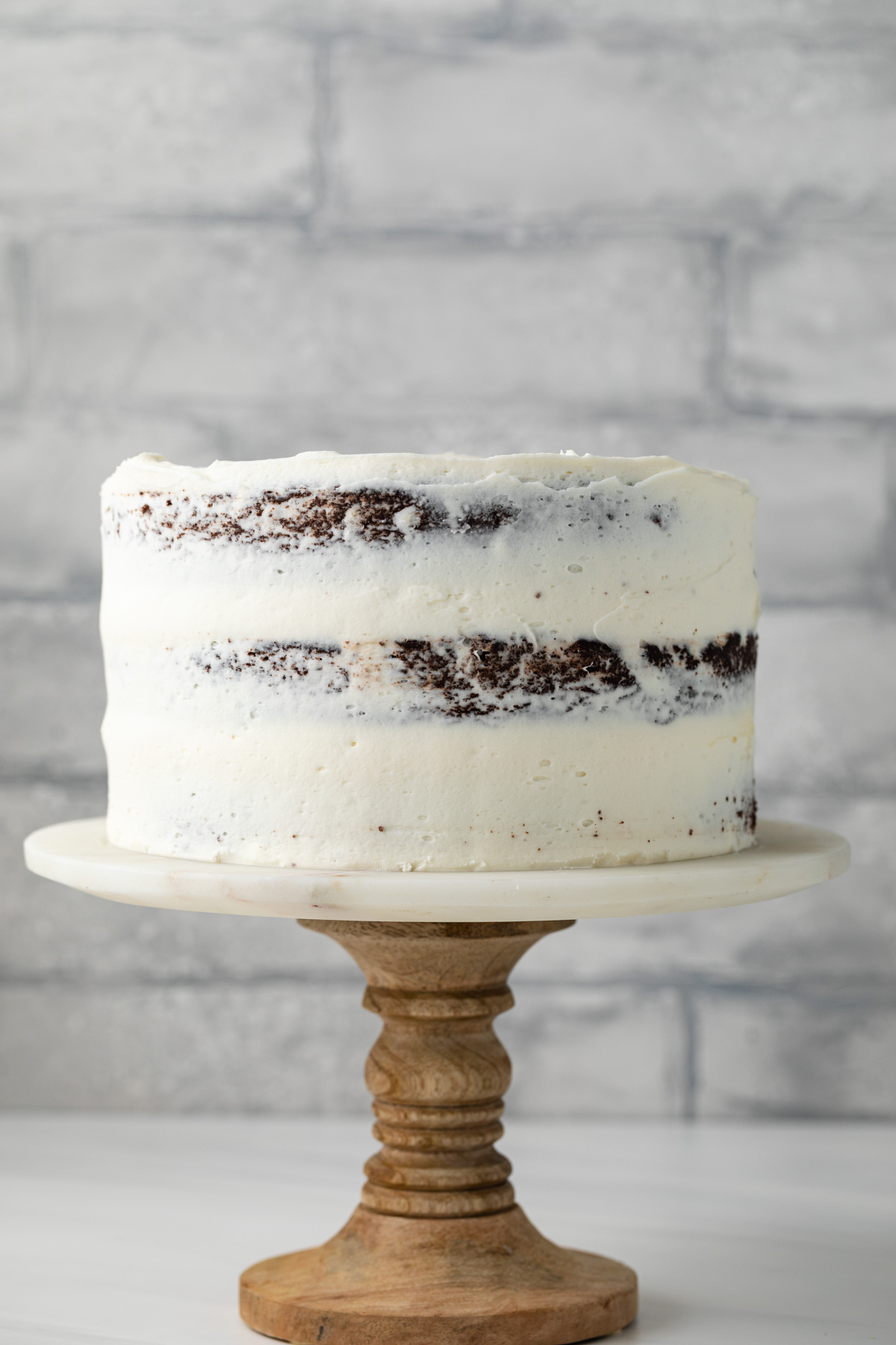 A layered chocolate coconut cake on a serving plate