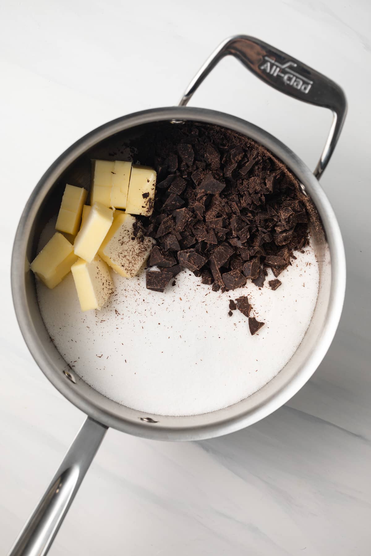 Sugar, butter, chocolate in saucepan.