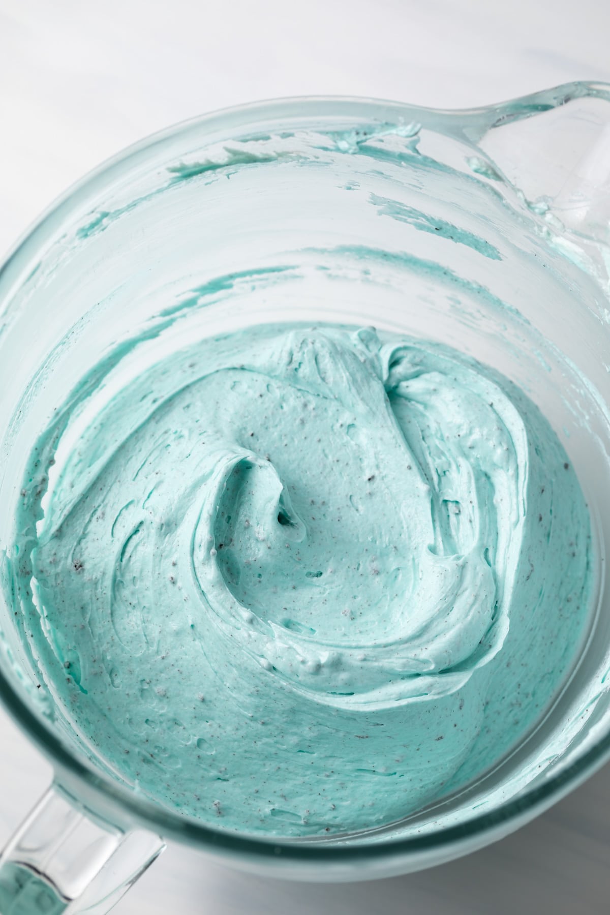 blue frosting in glass bowl