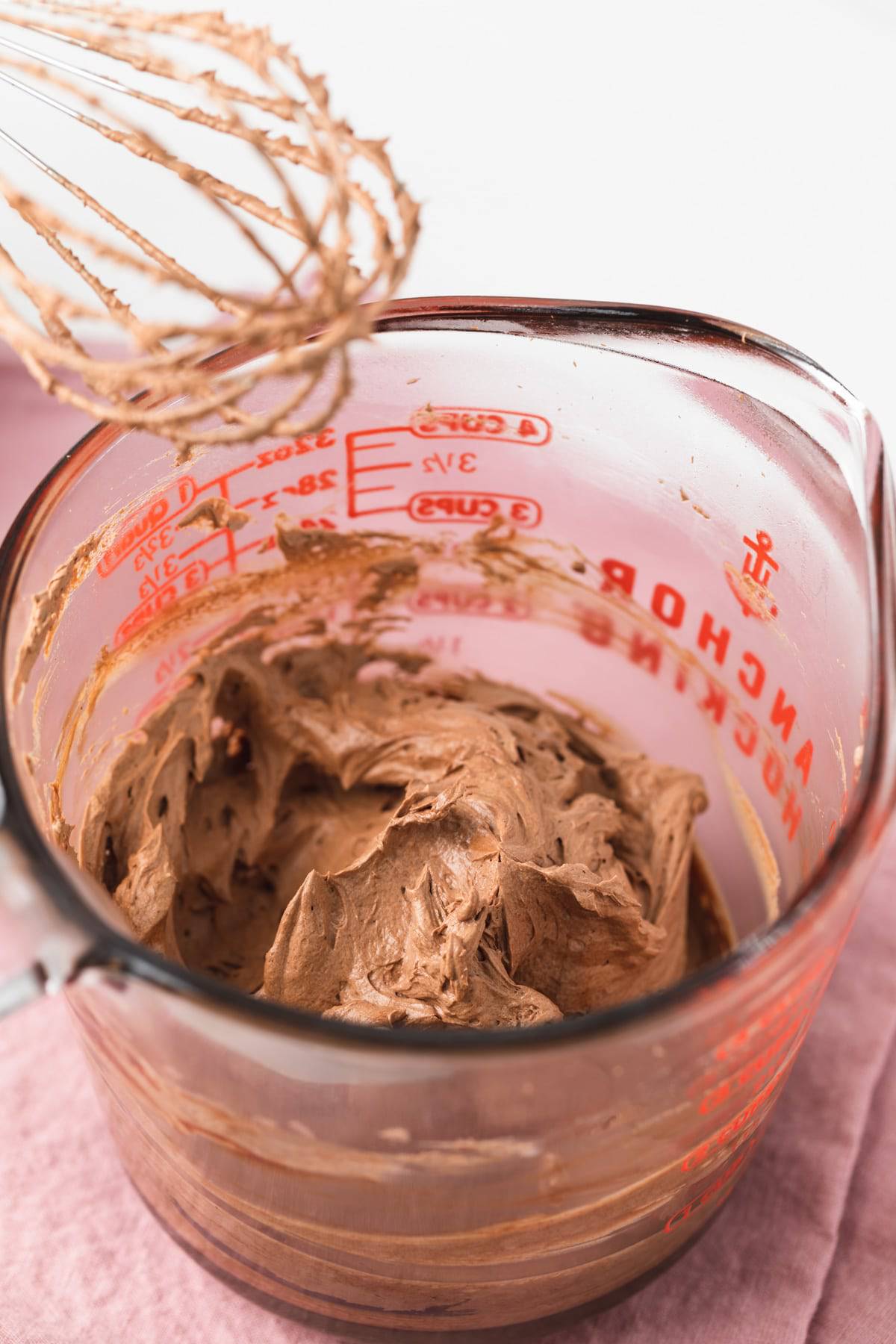 whipped chocolate ganache in a glass bowl