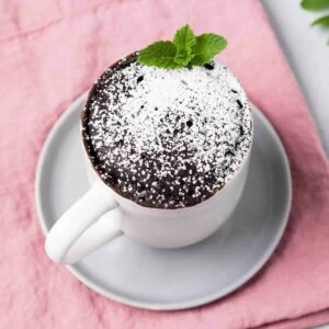 high angled view of chocolate mug cake on a grey plate