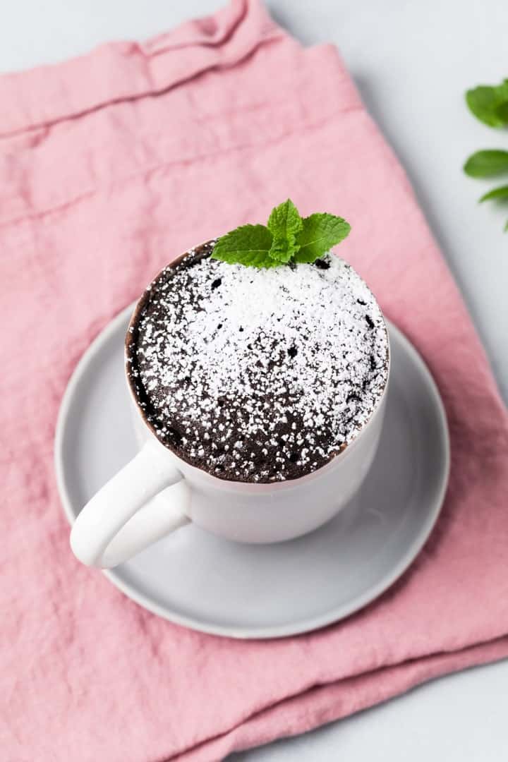 high angled view of chocolate mug cake on a grey plate
