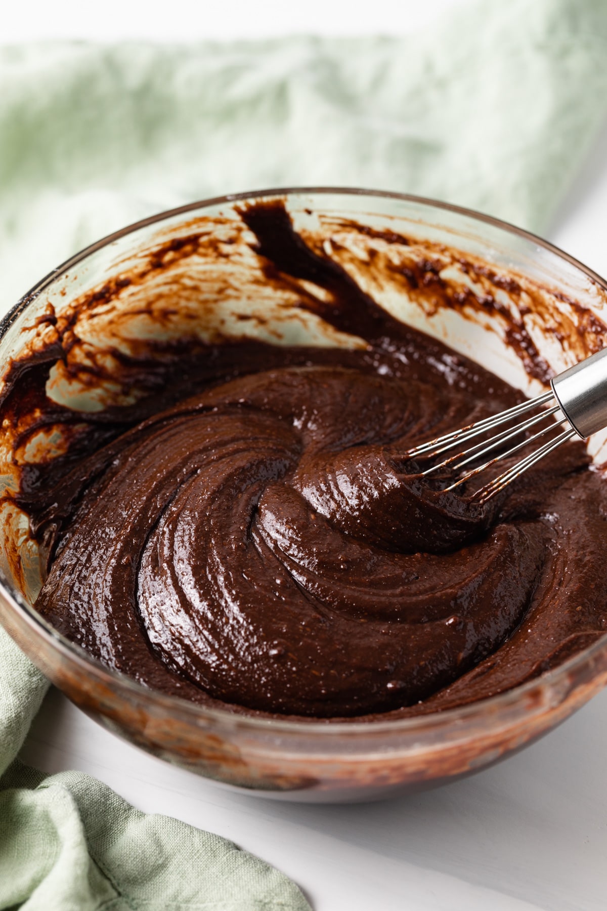 chocolate filling in glass bowl with whisk