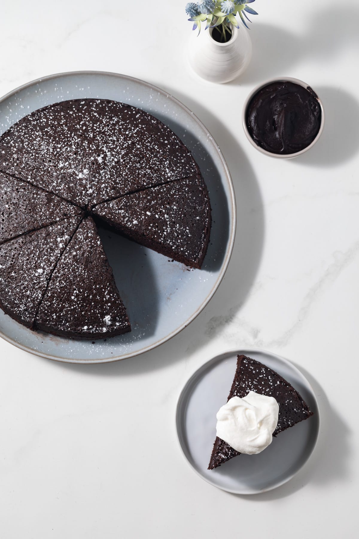 Chocolate olive oil cake with slice taken out.