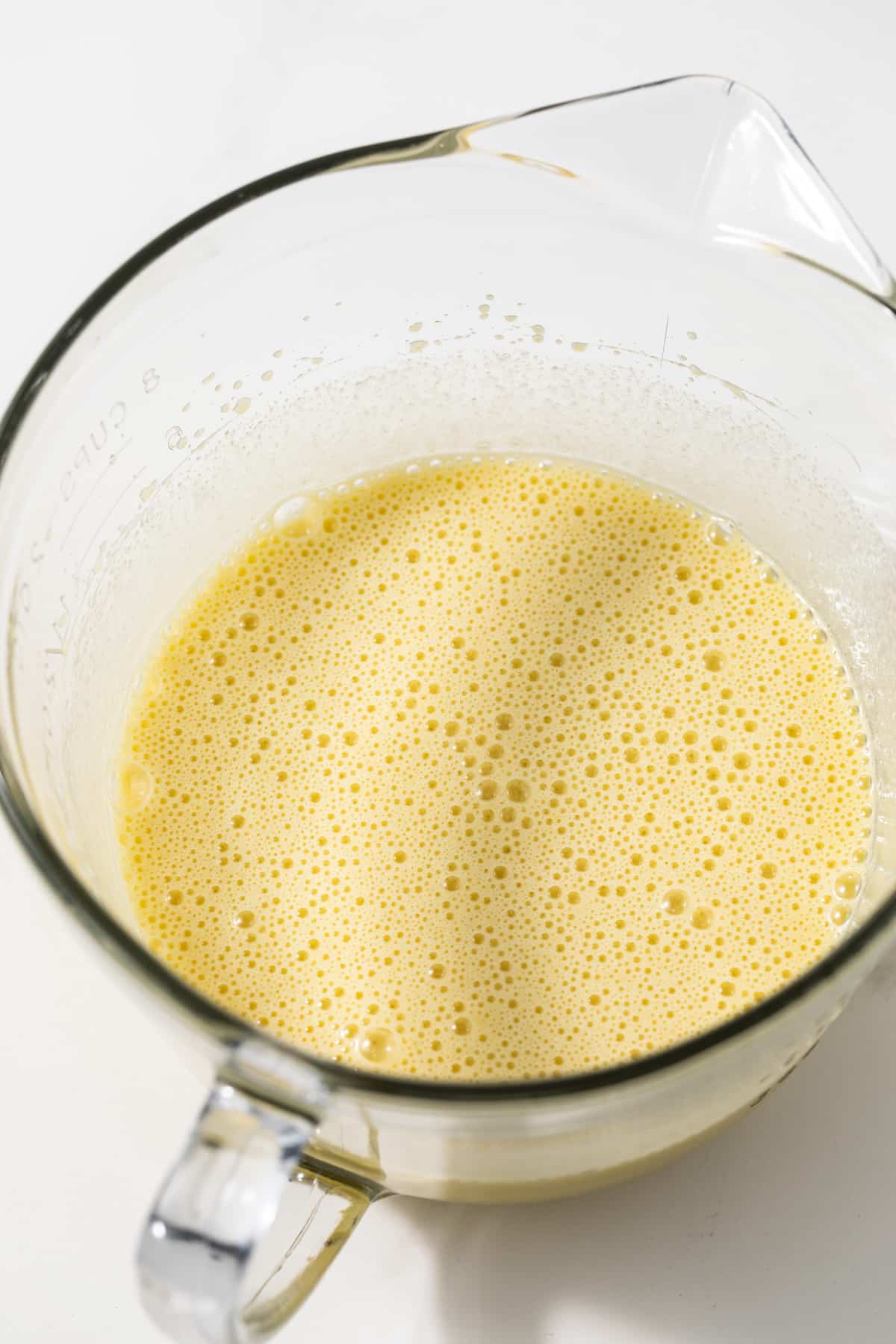 Mixed wet ingredients in glass bowl.