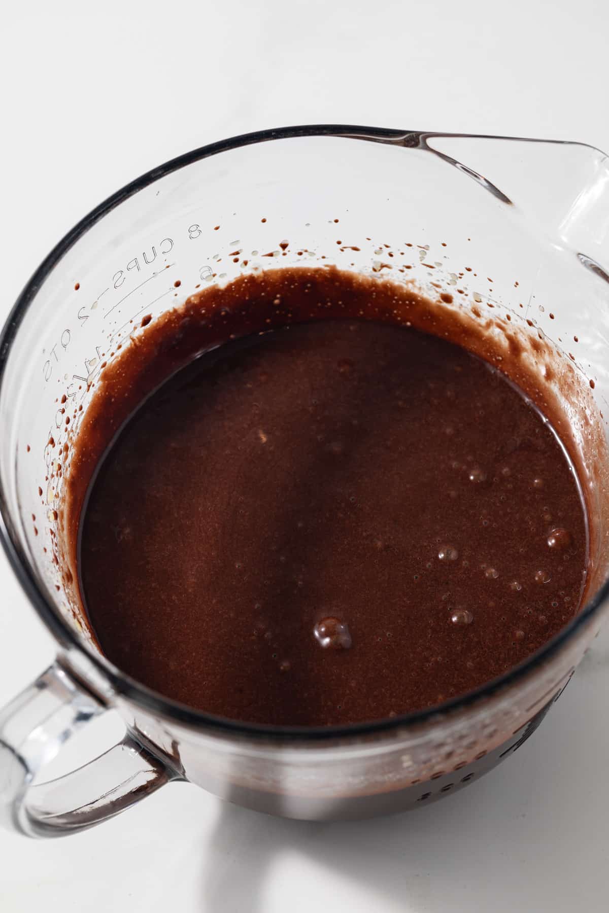 Chocolate olive oil cake batter in glass bowl.