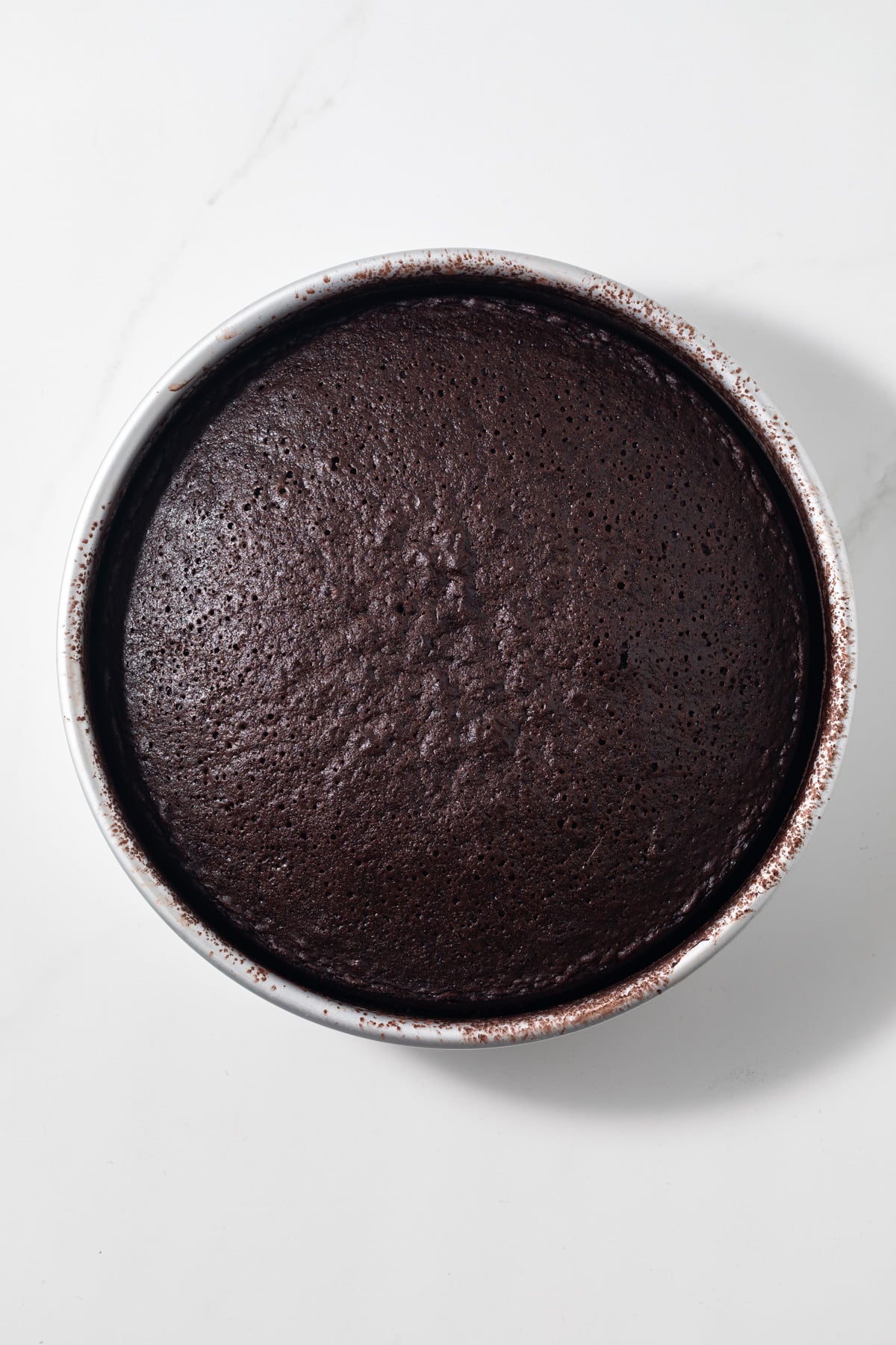 Baked cake in round baking pan.