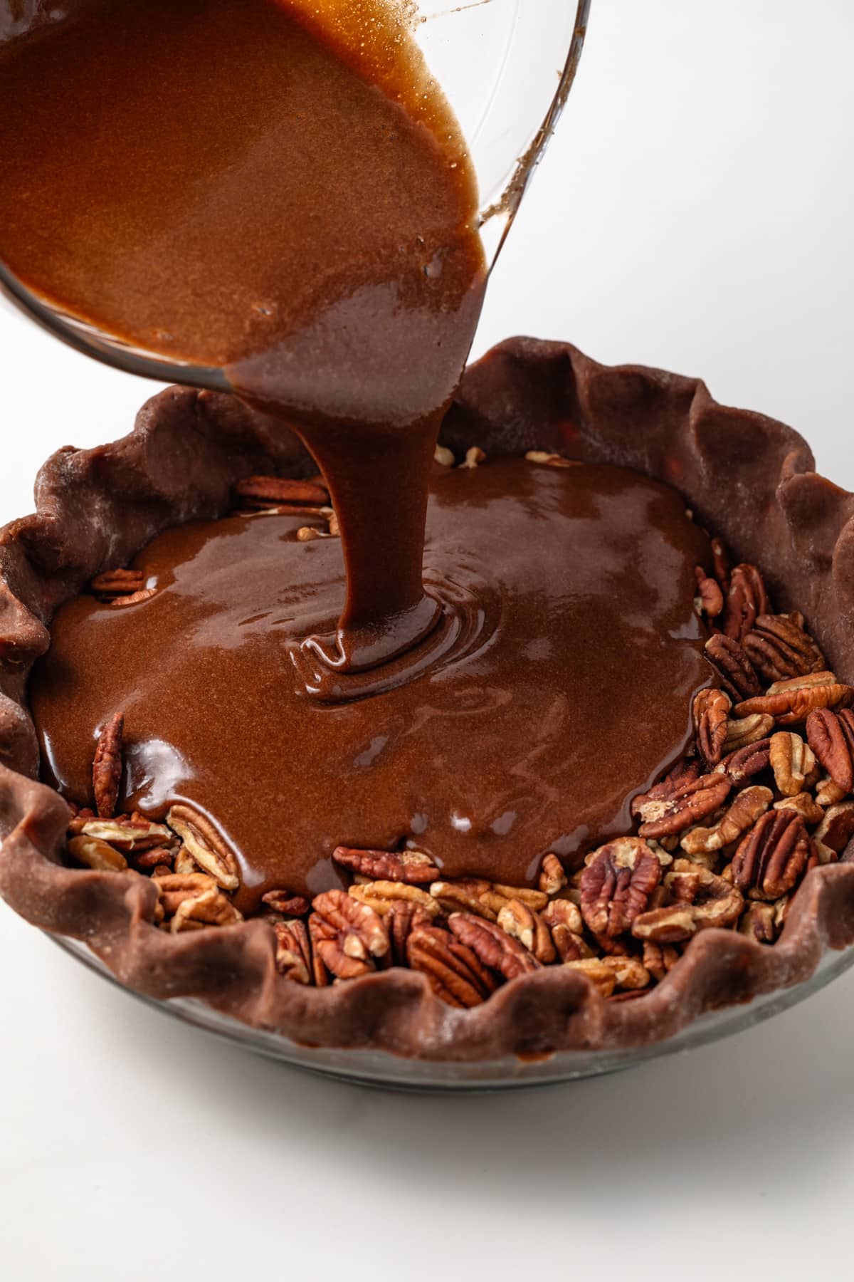 Chocolate filling poured over pecans in chocolate crust.