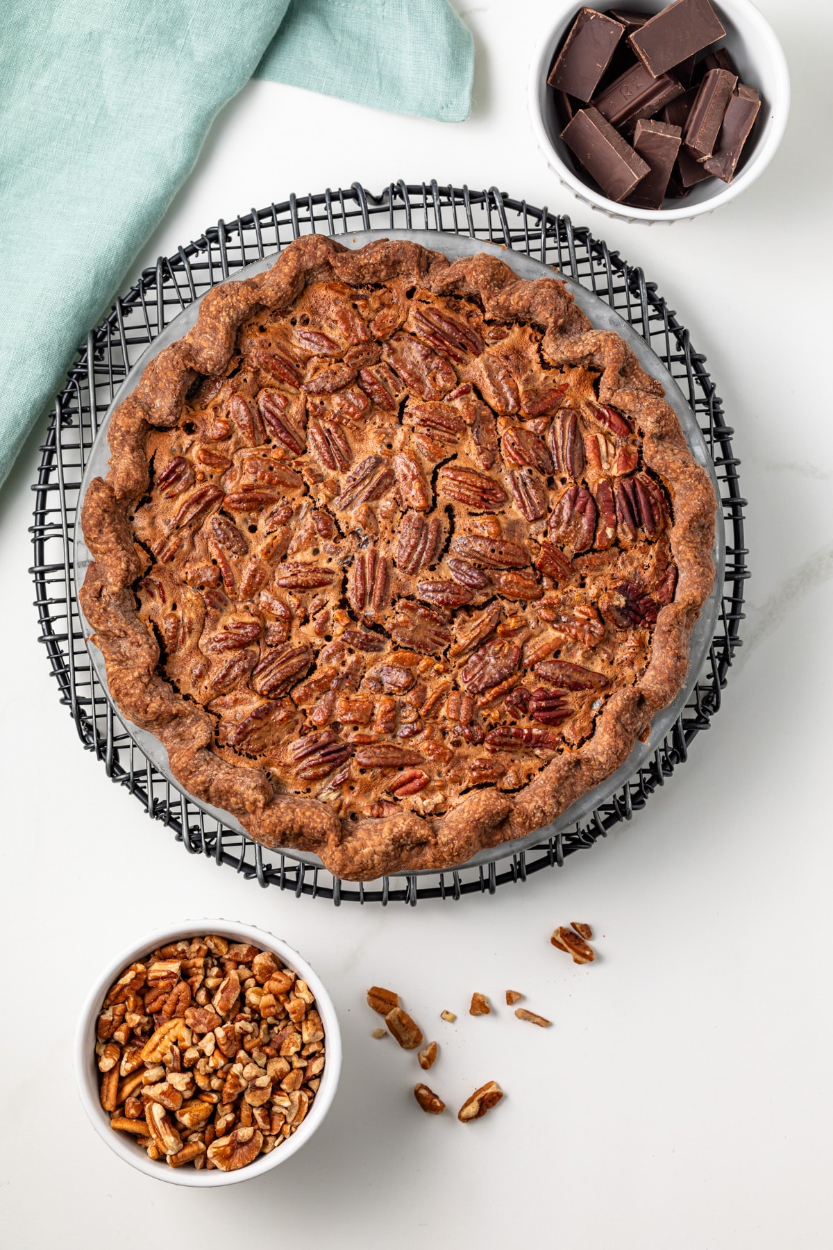 Whole chocolate pecan pie in pie pan.