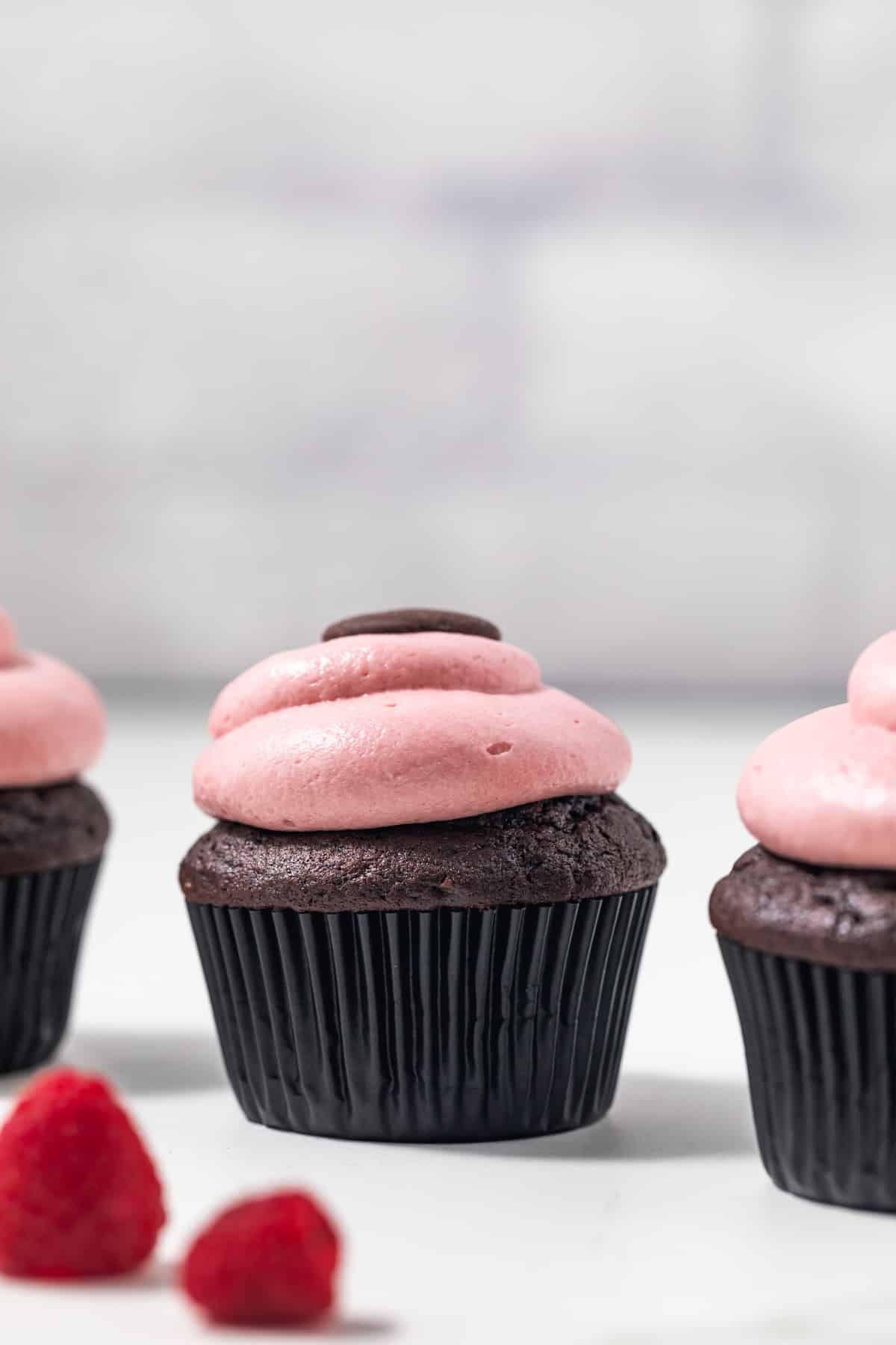 Side view of chocolate raspberry cupcakes.