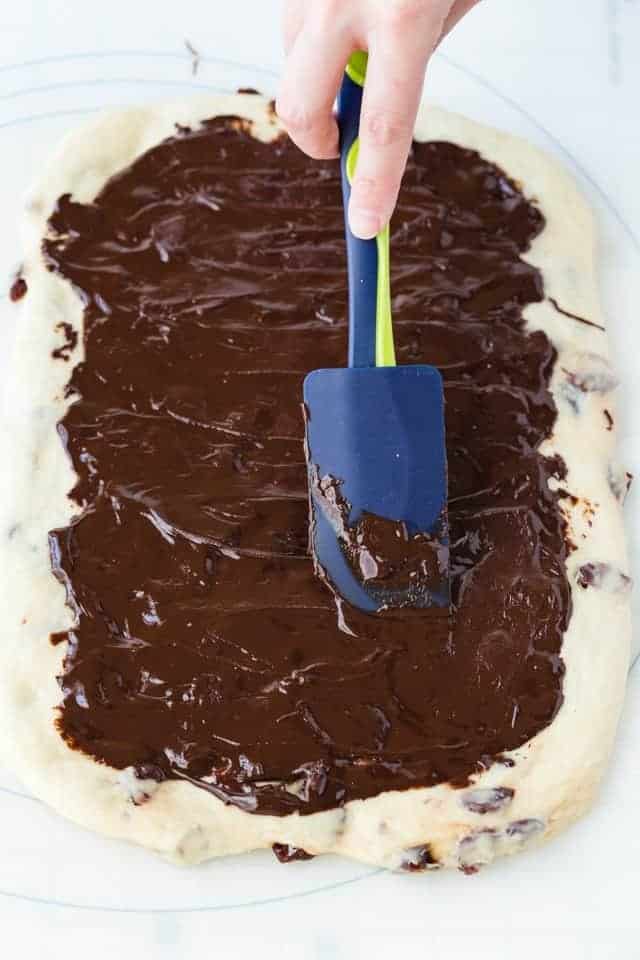 chocolate being spread over cherry bread