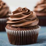side view of chocolate cupcake with chocolate Swiss frosting