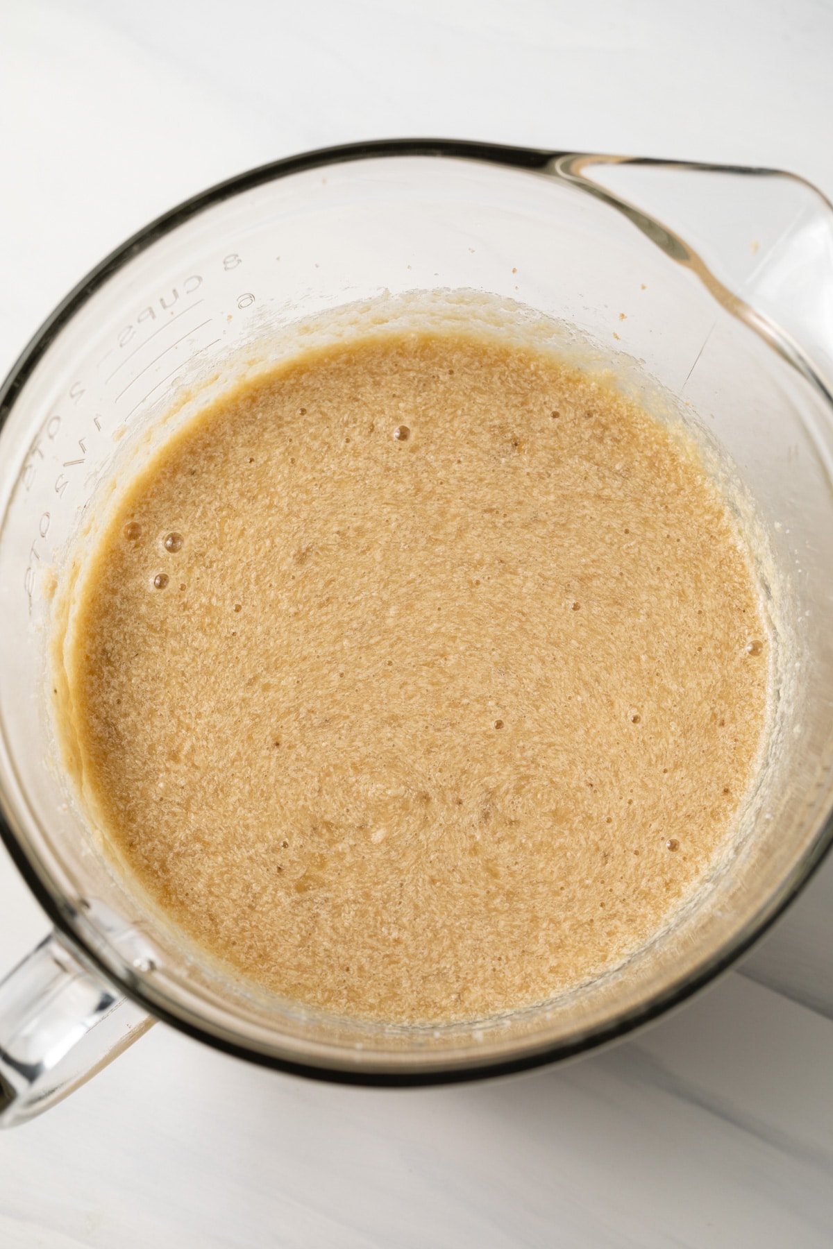 Wet ingredients combined in a glass bowl.