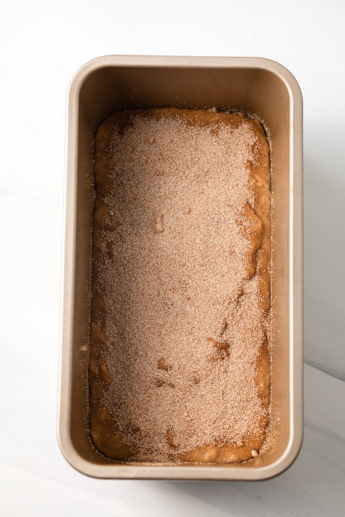 Banana bread batter layered with cinnamon sugar.