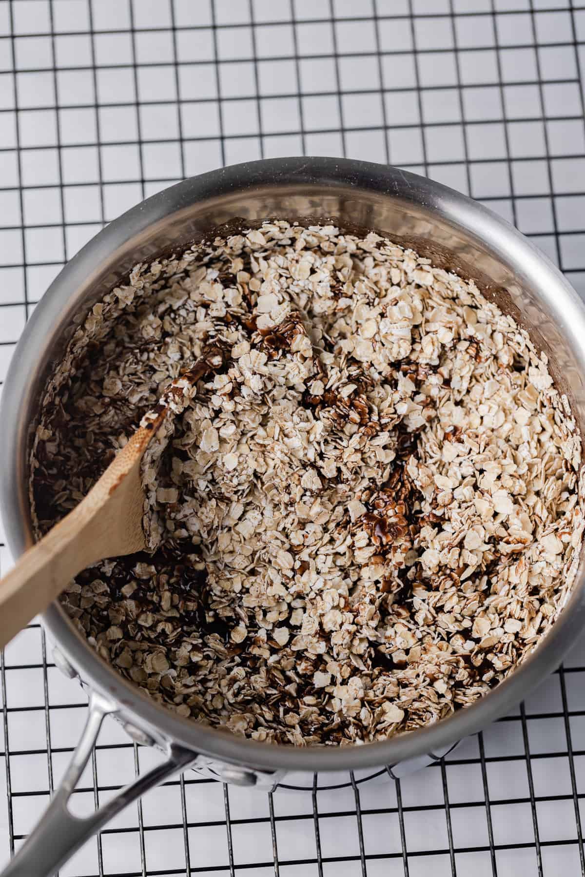 Oats being stirred into no bake cookie base
