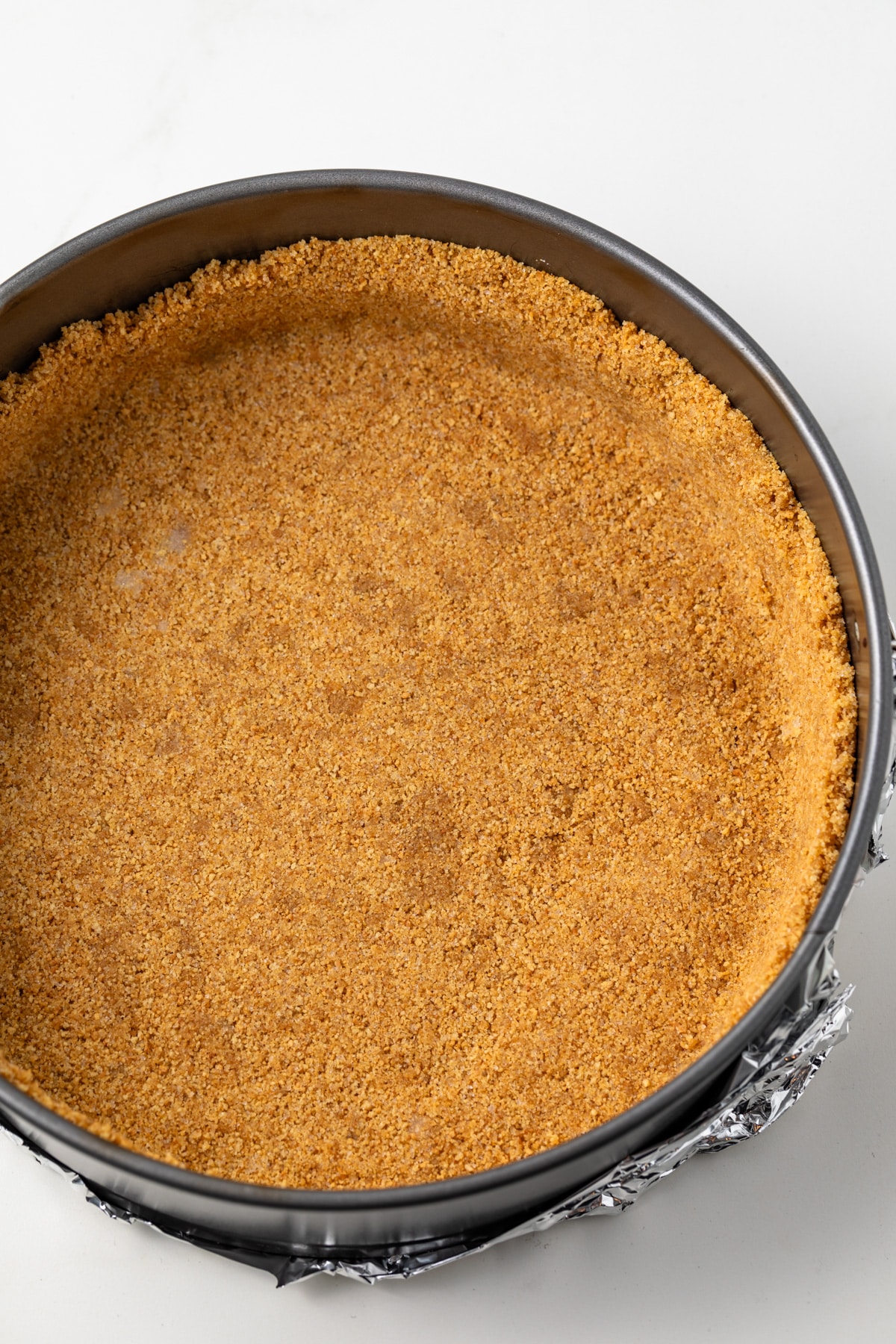 Graham cracker crust in springform pan.