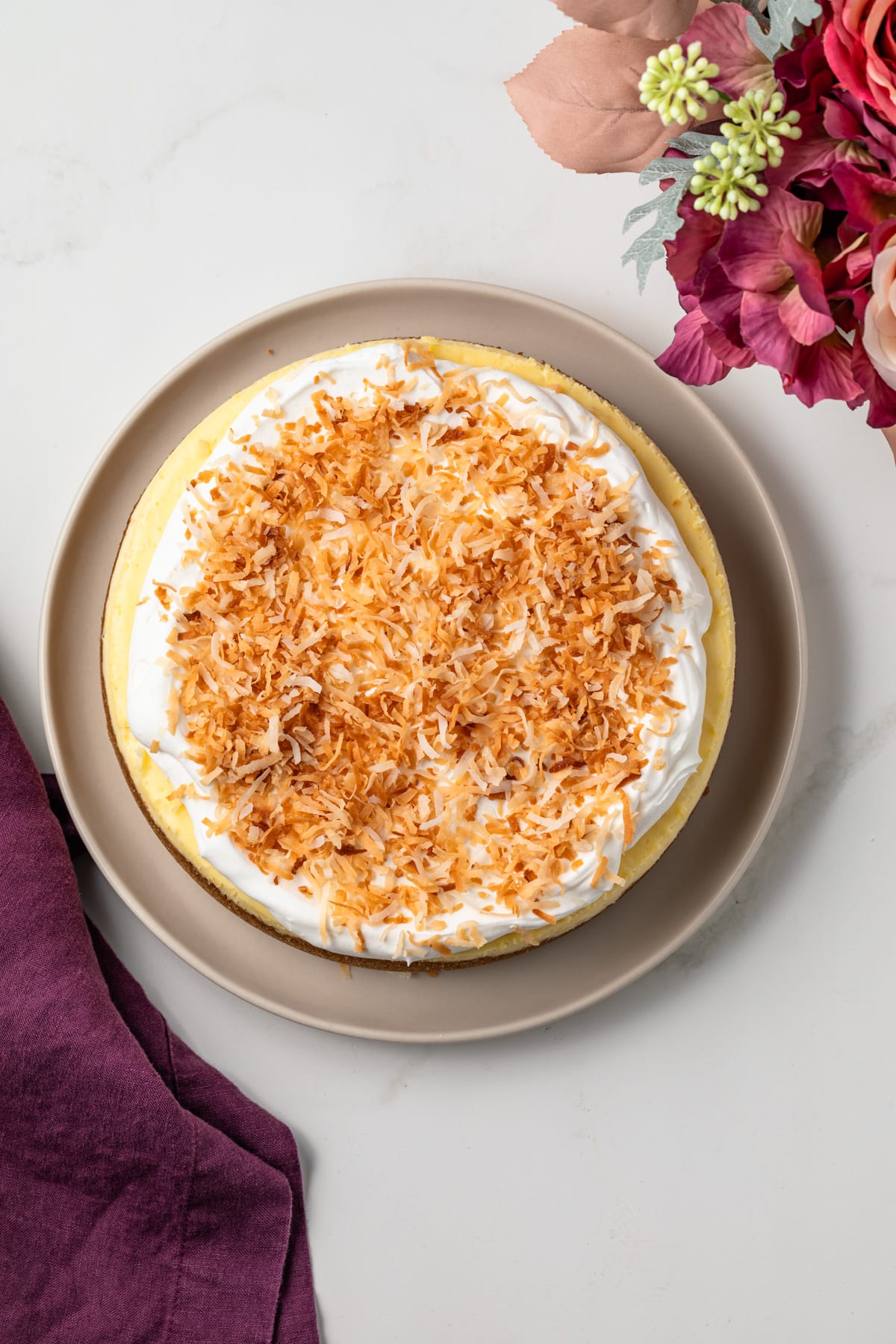 Overhead of coconut cheesecake on serving platter.
