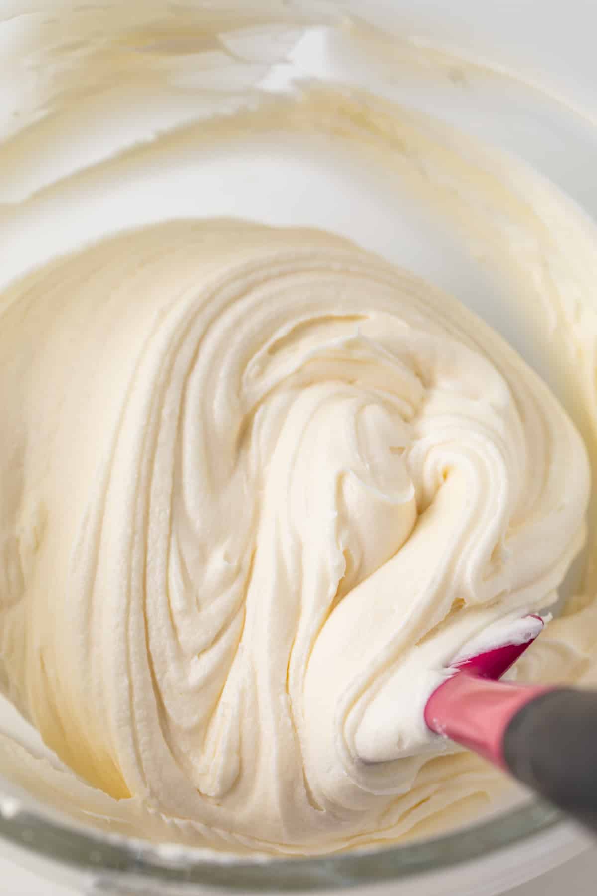 Coconut frosting in a glass bowl.