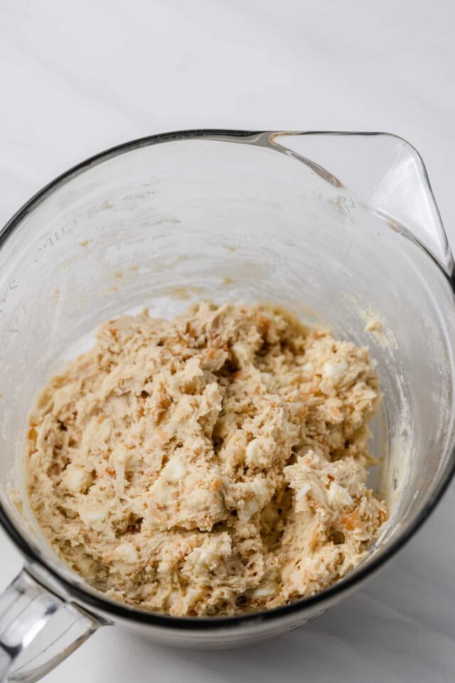 Coconut white chocolate chip cookie dough in a mixing bowl