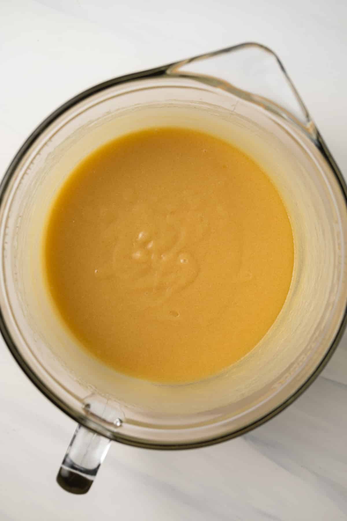 Wet ingredients mixed together in glass bowl.