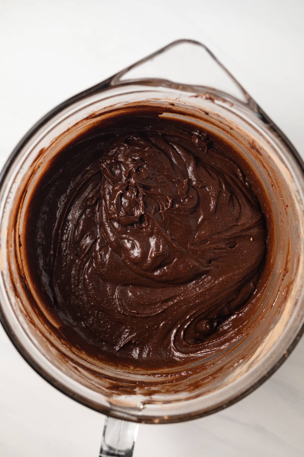 Brownie batter in glass bowl.