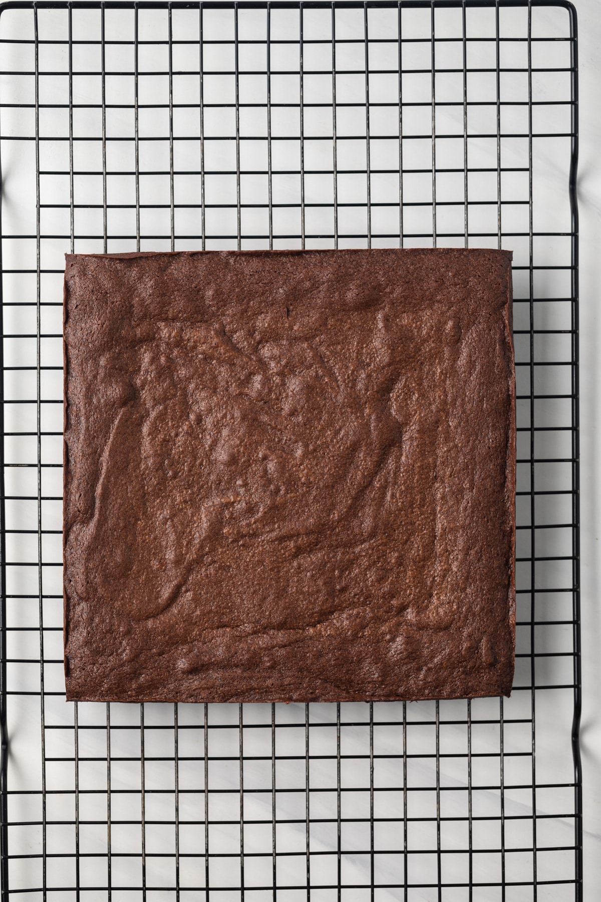 Baked brownies on wire rack.