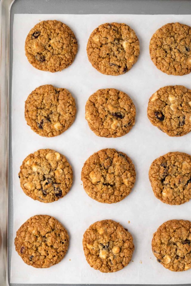 Freshly baked cranberry oatmeal cookies on a baking sheet