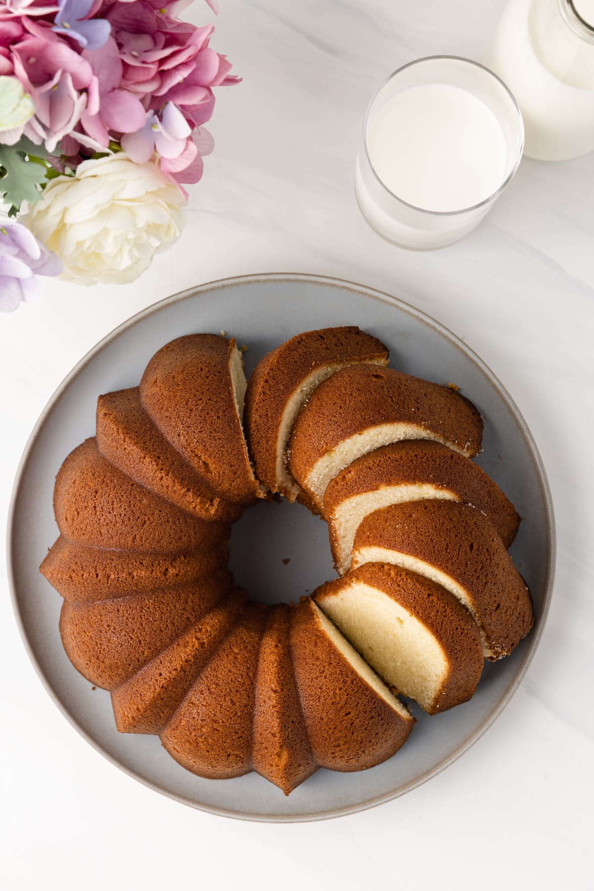 Overhead of cream cheese pound cake with slices cut.