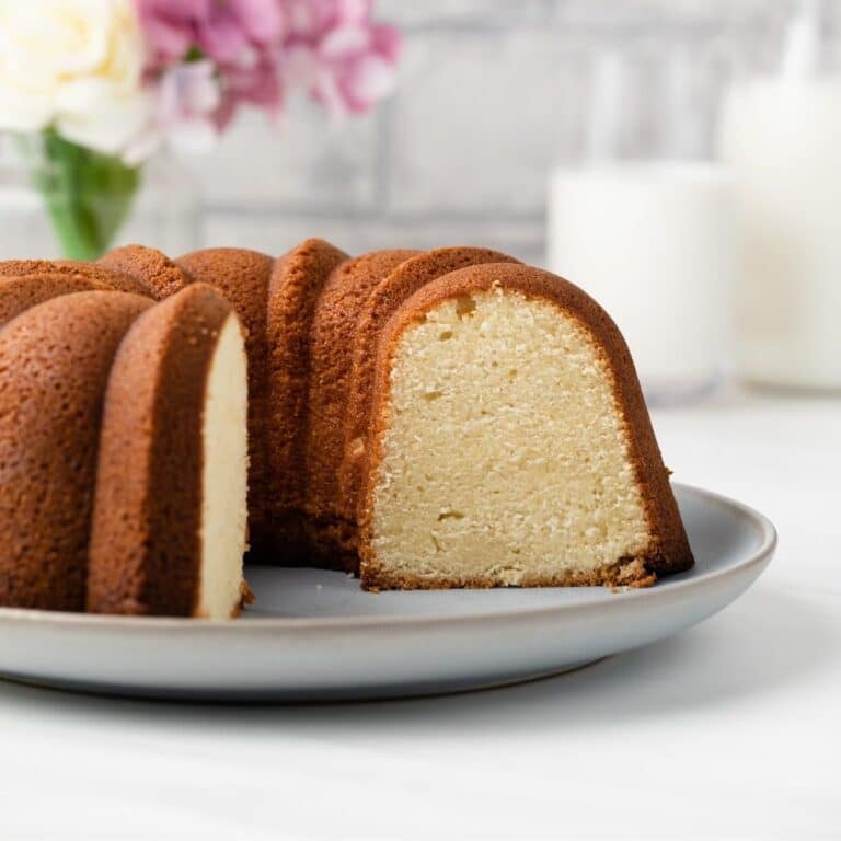 Cream cheese pound cake with slice taken out so inside is visible.