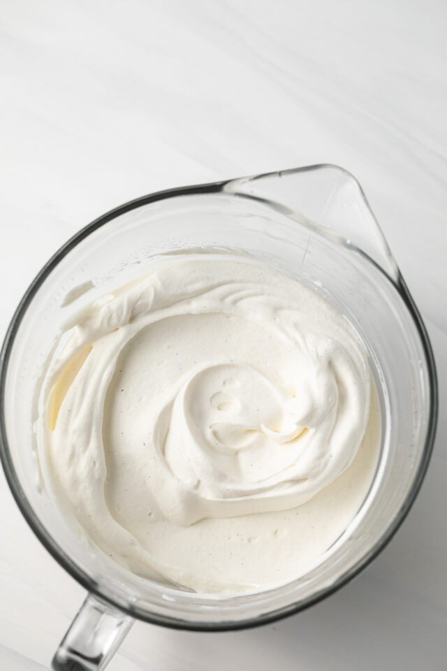 Whipped cream in a glass bowl.