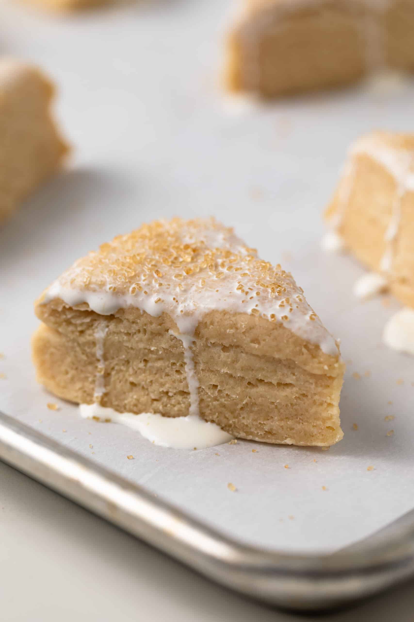 Unbaked scones with cream over the top.