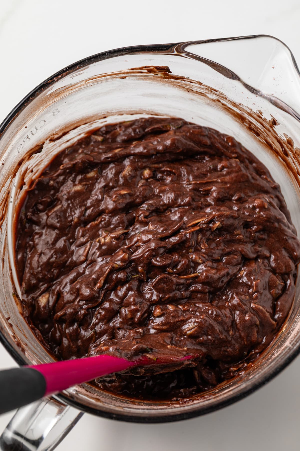 Chocolate zucchini bread batter in a glass bowl.