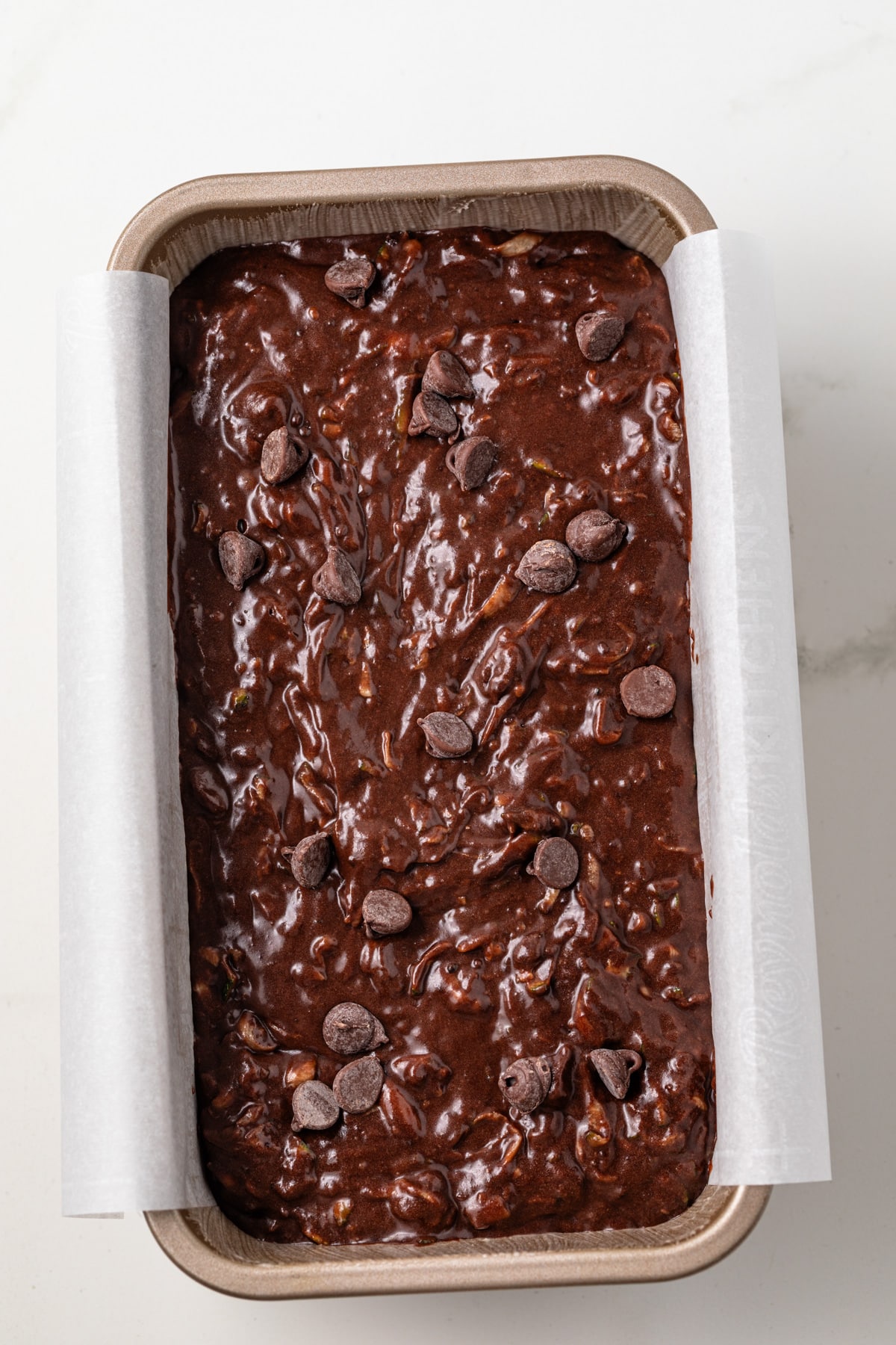 Chocolate zucchini bread batter in a loaf pan.