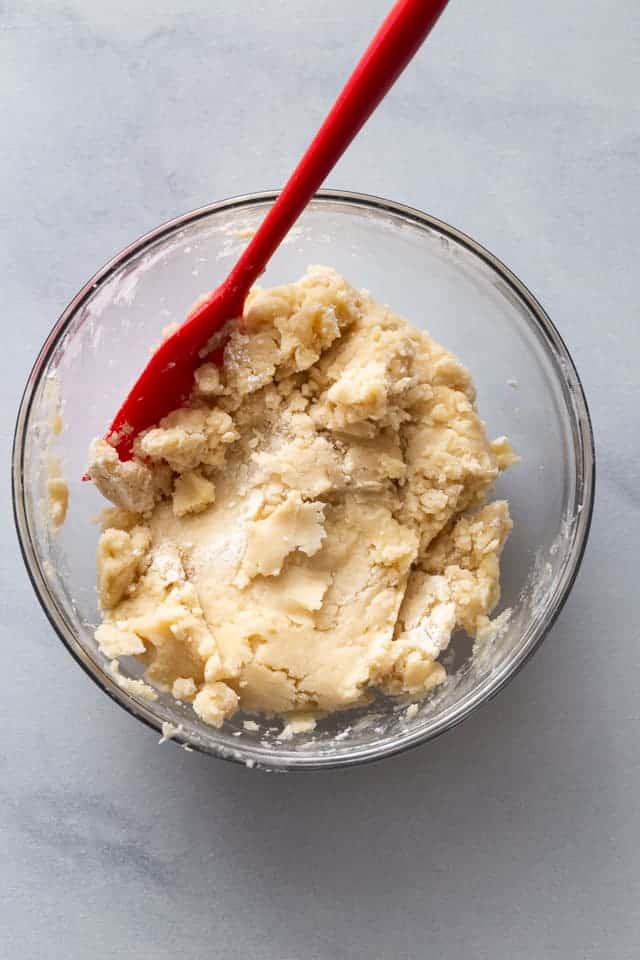 overhead view of crust dough in a glass bowl