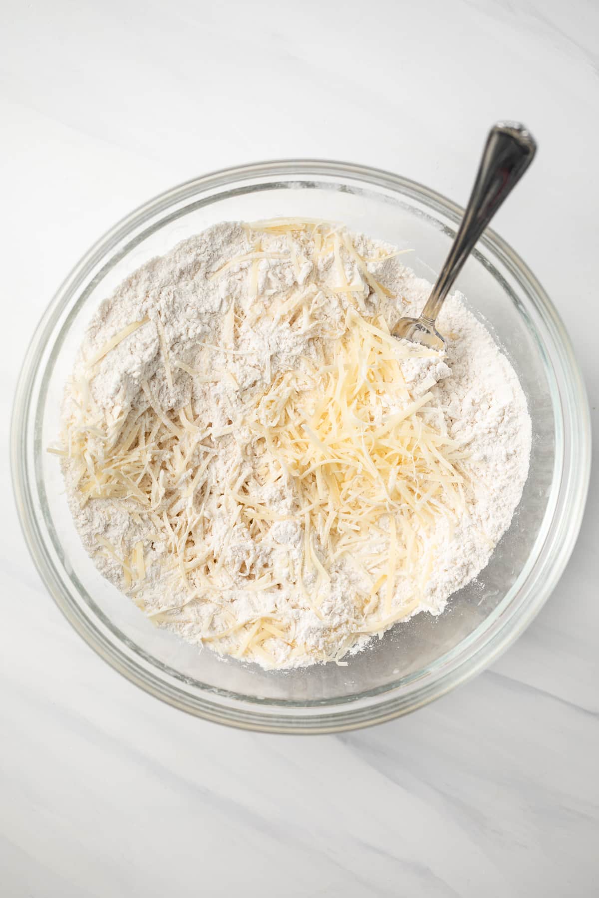 Dry ingredients mixed in glass bowl.