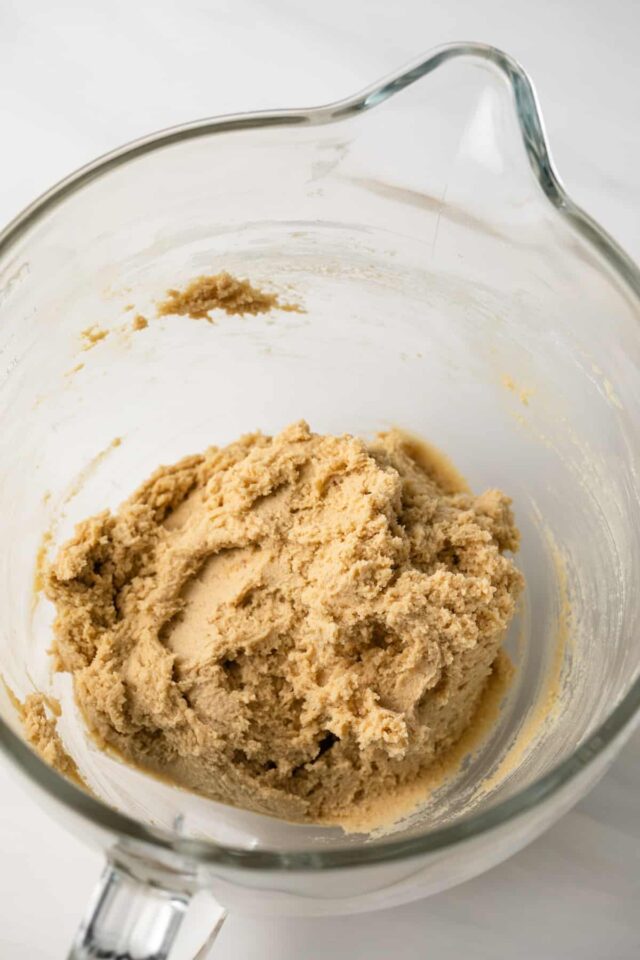 Dulce de leche thumbprint cookie dough in a mixing bowl
