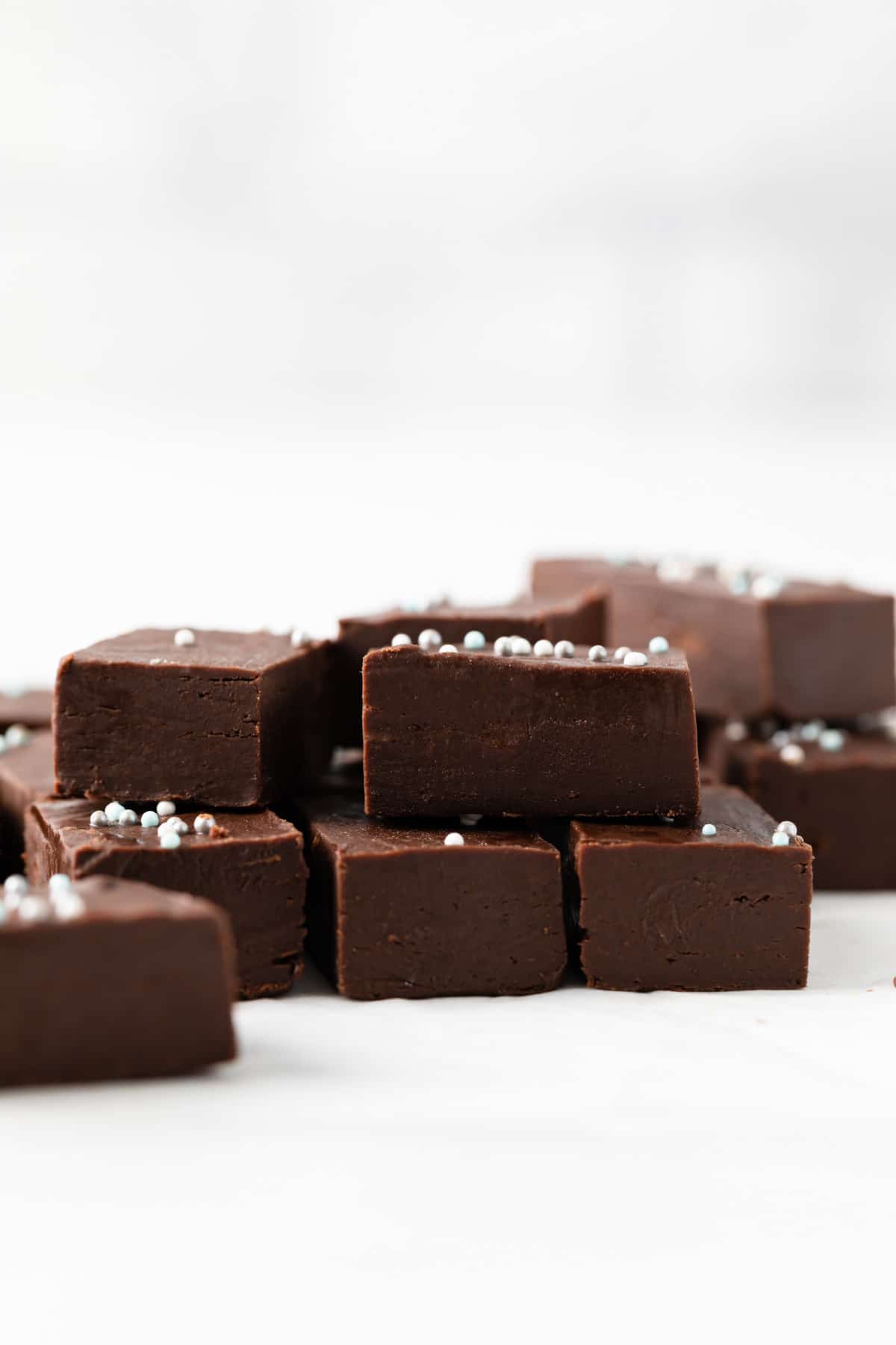 easy fudge squares stacked on white background