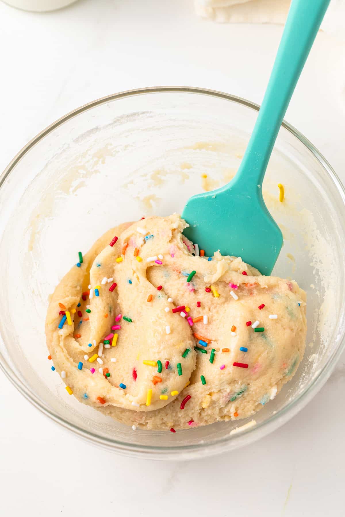 Sugar cookie dough in a glass bowl.