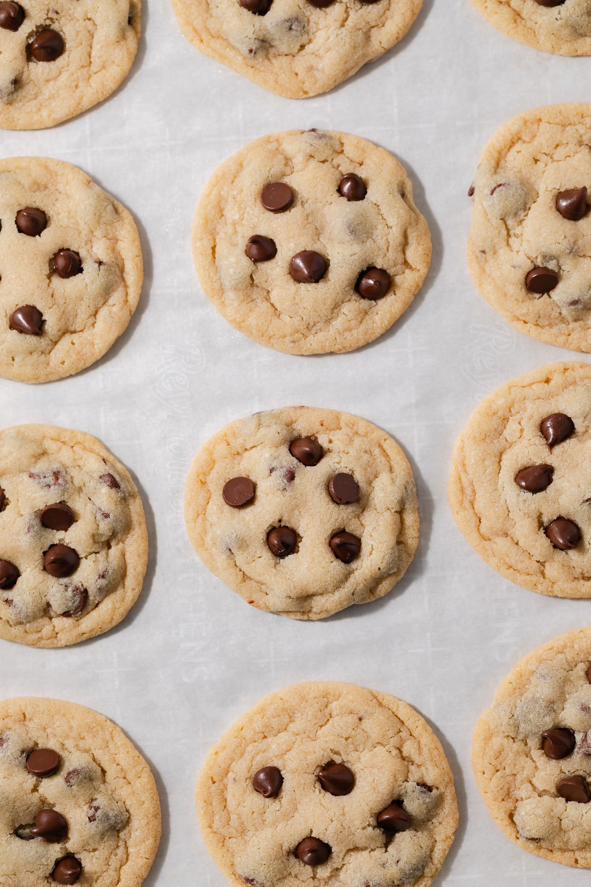 Baked eggless chocolate chip cookies on a baking sheet.