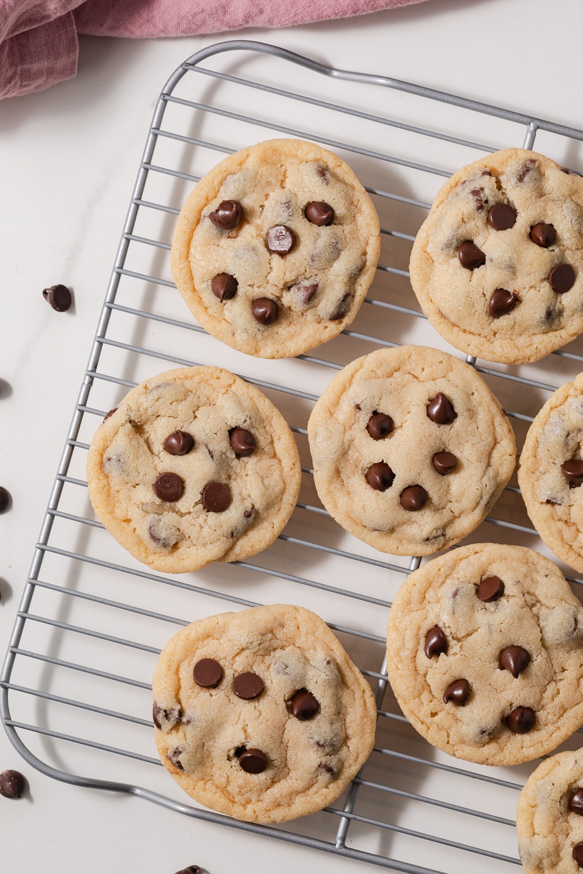 Eggless chocolate chip cookies on a wire rack.