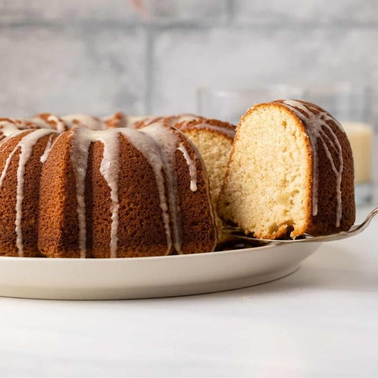 An eggnog bundt cake with one slice being served
